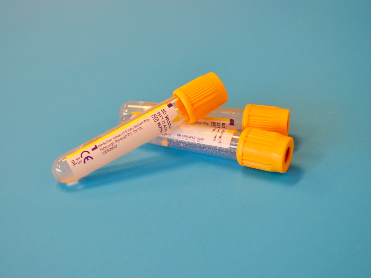 Blood collection tube with an amber cap on a clean surface